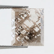 Emerald cut lab grown diamond featuring dramatic salt and pepper style inclusions with natural branching patterns, clear faceting and a unique galaxy-like internal structure.