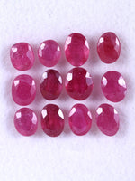 Row of red gemstones on a white background