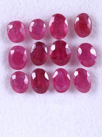 Row of red gemstones on a white background
