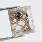 Emerald cut lab grown diamond featuring dramatic salt and pepper style inclusions with natural branching patterns, clear faceting and a unique galaxy-like internal structure.