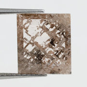 Emerald cut lab grown diamond featuring dramatic salt and pepper style inclusions with natural branching patterns, clear faceting and a unique galaxy-like internal structure.