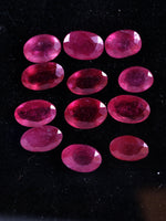 Oval-shaped rubies on a black background