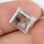Emerald cut lab grown diamond featuring dramatic salt and pepper style inclusions with natural branching patterns, clear faceting and a unique galaxy-like internal structure.