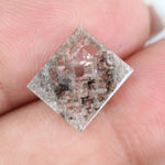 Emerald cut lab grown diamond featuring dramatic salt and pepper style inclusions with natural branching patterns, clear faceting and a unique galaxy-like internal structure.