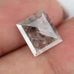 Emerald cut lab grown diamond featuring dramatic salt and pepper style inclusions with natural branching patterns, clear faceting and a unique galaxy-like internal structure.