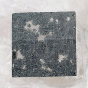 Square cut lab grown diamond with dramatic black and white salt and pepper galaxy inclusions in a geometric cut, showcasing a unique natural-looking pattern ideal for custom engagement rings or statement jewelry.