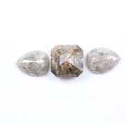 Three natural salt and pepper diamonds featuring two pear rose cut stones and one octagon step cut center diamond with visible inclusions and raw earthy tones, ideal for bespoke engagement ring or artisan jewelry design.