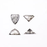 Four salt and pepper lab grown diamonds in shield, trillion, and geometric fancy cuts with natural grey inclusions, displayed on white background as loose ethical conflict-free stones for custom jewelry.