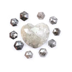 Large natural salt and pepper diamond heart surrounded by matching hexagon rose cut natural diamonds with visible galaxy-style inclusions on white background