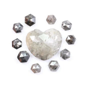 Large natural salt and pepper diamond heart surrounded by matching hexagon rose cut natural diamonds with visible galaxy-style inclusions on white background