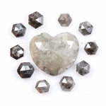 Large natural salt and pepper diamond heart surrounded by matching hexagon rose cut natural diamonds with visible galaxy-style inclusions on white background