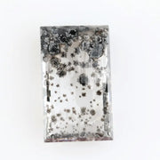 Rectangular step cut lab grown diamond featuring dramatic black dendritic inclusions in a salt and pepper pattern, creating a unique one of a kind modern alternative diamond with striking natural looking carbon formations inside a clear faceted stone.