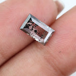 Rectangular step cut lab grown diamond featuring dramatic black dendritic inclusions in a salt and pepper pattern, creating a unique one of a kind modern alternative diamond with striking natural looking carbon formations inside a clear faceted stone.