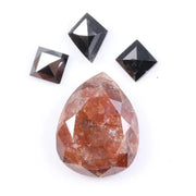 Large natural pear-shaped orange diamond with visible inclusions, surrounded by three black geometric-cut natural diamonds on a white background.