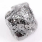 Raw uncut gray diamond showing natural crystal structure