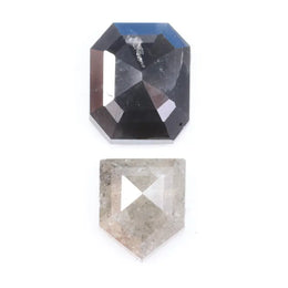 Natural black octagon-cut diamond and shield-cut salt-and-pepper diamond displayed on white background, showing unique inclusions and rustic faceting details.