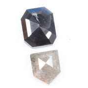 Natural black octagon-cut diamond and shield-cut salt-and-pepper diamond displayed on white background, showing unique inclusions and rustic faceting details.