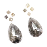 Large pear shaped salt and pepper natural diamond with dramatic black and grey inclusions paired with kite shaped accent diamonds, rustic galaxy diamond set ideal for alternative engagement ring or custom fine jewelry design.