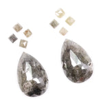 Large pear shaped salt and pepper natural diamond with dramatic black and grey inclusions paired with kite shaped accent diamonds, rustic galaxy diamond set ideal for alternative engagement ring or custom fine jewelry design.