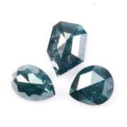 Three natural teal blue diamonds featuring pear, oval, and shield cuts with visible galaxy-like inclusions, rare salt and pepper natural diamonds ideal for custom jewelry design