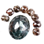 Large natural green diamond surrounded by fancy cognac brown natural diamonds arranged in a semicircle, showcasing rare earth-mined colored diamonds with visible natural inclusions and unique faceting.