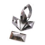 Set of natural salt and pepper diamonds with dark galaxy inclusions in mixed faceted shapes including marquise, kite and baguette cut stones for unique custom jewelry or engagement ring designs.