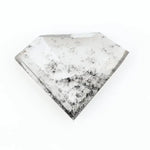 Shield cut lab grown diamond with clear body and natural-looking black inclusions in a salt and pepper pattern, faceted loose gemstone for custom jewelry