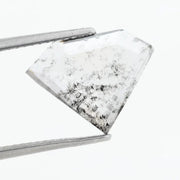 Shield cut lab grown diamond with clear body and natural-looking black inclusions in a salt and pepper pattern, faceted loose gemstone for custom jewelry