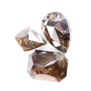 Three natural brown diamonds with unique cuts and facets, showcasing a rich, earthy hue and natural inclusions, perfect for fine jewelry or collectors.
