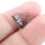 Shield cut lab grown diamond with clear body and natural-looking black inclusions in a salt and pepper pattern, faceted loose gemstone for custom jewelry