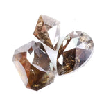 Three natural brown diamonds with unique cuts and facets, showcasing a rich, earthy hue and natural inclusions, perfect for fine jewelry or collectors.