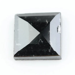 Close-up of a princess cut lab-grown diamond with square shape, sharp facets, and visible inclusions, showcasing modern geometric brilliance and ethical gemstone craftsmanship for jewelry making