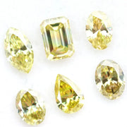 Fancy yellow lab grown loose diamonds in marquise pear oval and emerald cut shapes for luxury jewelry making