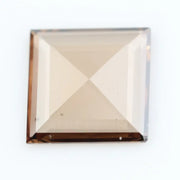 Square pyramid cut lab grown diamond with soft champagne tone, high clarity, polished facets, and modern geometric shape on a clean white background