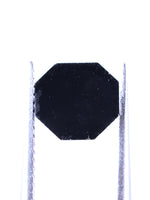 Black octagonal object on a white background