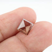 Square pyramid cut lab grown diamond with soft champagne tone, high clarity, polished facets, and modern geometric shape on a clean white background