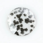 Round faceted lab grown diamond with distinctive black inclusions creating a salt and pepper effect inside a clear polished gemstone