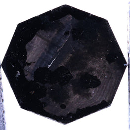 Black faceted lab grown diamond  on a white background