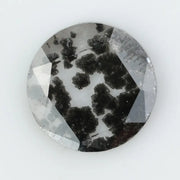 Round cut lab grown salt and pepper diamond featuring bold black dendritic inclusions in a transparent stone, faceted for brilliance and showcasing a unique natural pattern