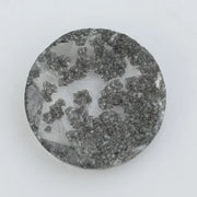 Round cut lab grown salt and pepper diamond featuring bold black dendritic inclusions in a transparent stone, faceted for brilliance and showcasing a unique natural pattern