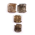 Emerald cut champagne brown lab grown diamond with step cut facets and visible natural-style inclusions, sustainable loose diamond for custom engagement ring or fine jewelry design.