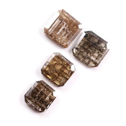 Emerald cut champagne brown lab grown diamond with step cut facets and visible natural-style inclusions, sustainable loose diamond for custom engagement ring or fine jewelry design.