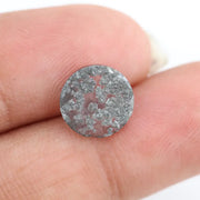 Round cut lab grown salt and pepper diamond featuring bold black dendritic inclusions in a transparent stone, faceted for brilliance and showcasing a unique natural pattern