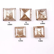 Five square step cut champagne lab grown diamonds with galaxy salt and pepper inclusions, pyramid faceting, and rustic brown tones displayed on a white background.