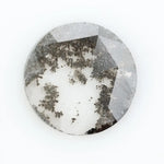 Round faceted lab grown diamond with distinctive salt and pepper style inclusions creating a galaxy-like pattern, showcasing a unique and modern alternative to traditional clear diamonds