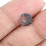 Round faceted lab grown diamond with distinctive salt and pepper style inclusions creating a galaxy-like pattern, showcasing a unique and modern alternative to traditional clear diamonds