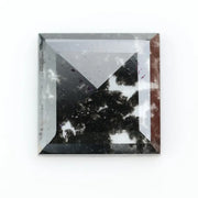 Square cut lab grown diamond with step facets, high clarity, mirror-like reflections, and visible inclusions on a neutral background