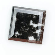 Square cut lab grown diamond with step facets, high clarity, mirror-like reflections, and visible inclusions on a neutral background