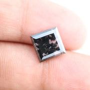 Square cut lab grown diamond with step facets, high clarity, mirror-like reflections, and visible inclusions on a neutral background