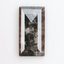 Rectangular step cut lab grown diamond featuring bold black salt and pepper inclusions with mirror-like facets and a modern geometric shape